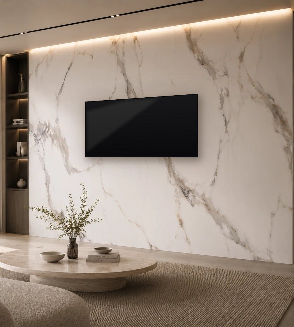 Full-height Carrara marble wall with a wall-mounted TV and cove lighting